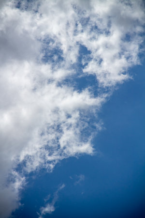 Textured background of white and blue clouds visible during the dayの写真素材