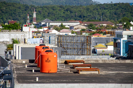 The orange water tower is on top of the buildingの写真素材