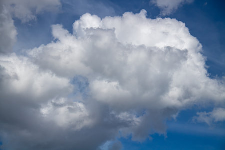 Textured background of white and blue clouds visible during the dayの写真素材