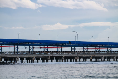The bridge to transport goods from the crane to the warehouse on the seafrontの写真素材