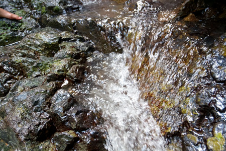 The water flow in the river that passes through the rocksの写真素材