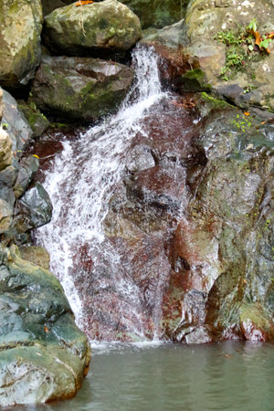 The water flow in the river that passes through the rocksの写真素材