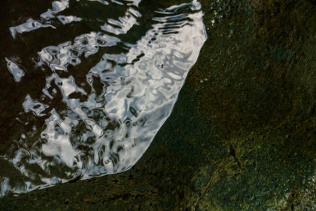Close up of a water surface on a rock in the river.の写真素材