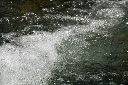 Waterfall in the forest, close-up of water splashesの写真素材