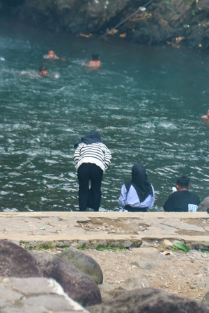 A group of women sitting by the riverの写真素材