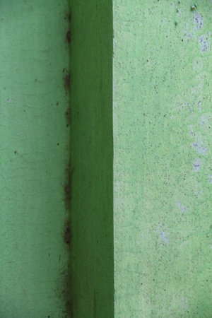 The texture of the wall is painted green which is starting to fade. Abstract background and texture for design.の写真素材
