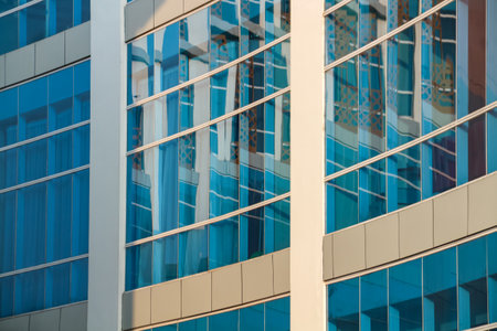 Close up of modern office building with blue glass facade. Business backgroundの写真素材