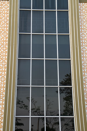 Detail of the facade of a modern house with a decorative windowの写真素材