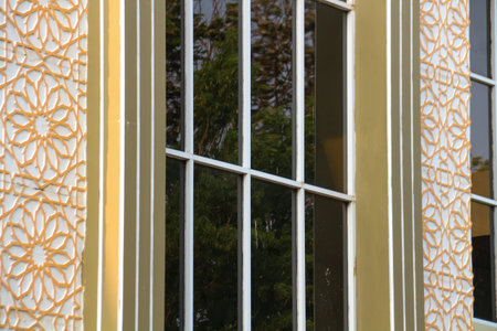 Detail of the facade of a modern house with a decorative windowの写真素材