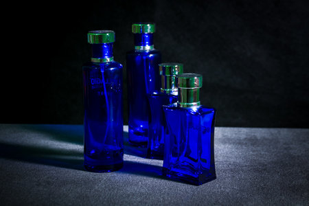 Collection of blue glass perfume bottles on black backgroundの写真素材