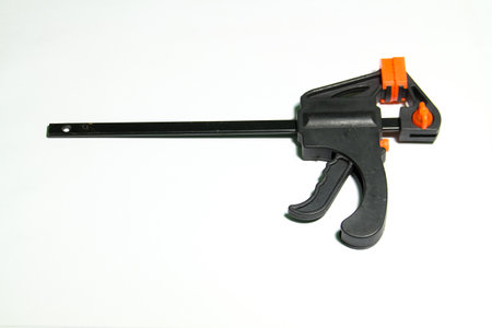 Black plastic clamp gun isolated on white background. Studio photo.の写真素材