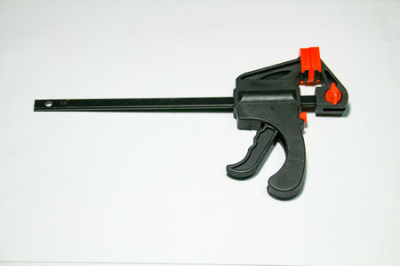 Black plastic clamp gun isolated on white background. Studio photo.の写真素材