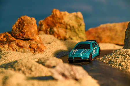 Miniature toy car on the beach at sunset, travel concept.の写真素材