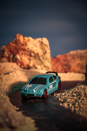 Closeup of toy car on the beach at sunsetの写真素材