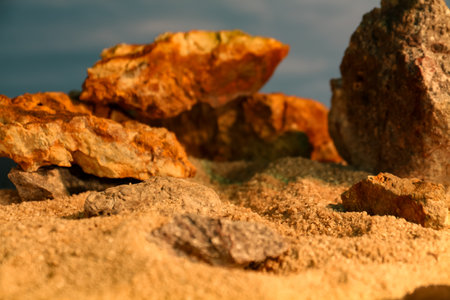 The background theme is rocks and sand with bright light like the afternoon sunの写真素材