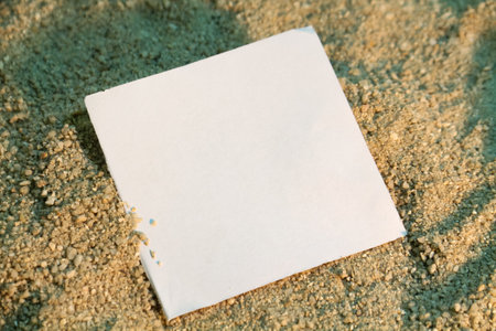 Blank paper on sand background with copy space for your text.の写真素材