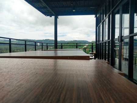 Wooden table and chair in the cafe. View from the terrace.