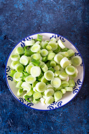 Fresh raw leek slice in a bowl. Washed sliced ready-to-cook leeks.の写真素材