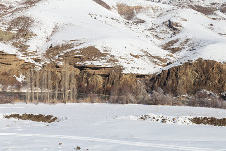 Snowy landscape from the train window. Snowy mountains. Winter landscape.