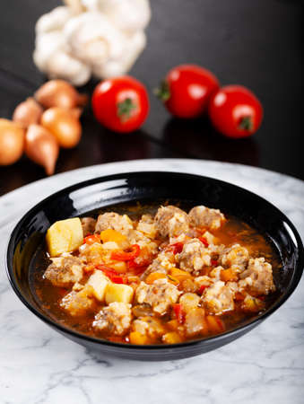 Soup with meatball and vegetables on stone background.の写真素材