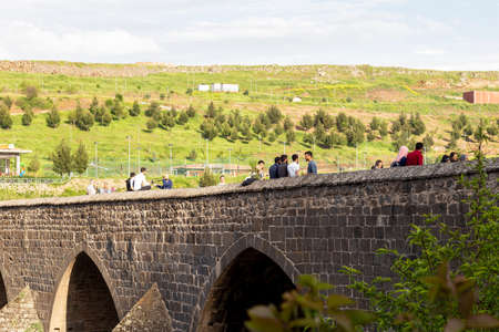 Diyarbakir/Turkey - 05/06/2019: The Dicle Bridge is a historic bridge in DiyarbakÄ±r over the river Tigris (Turkish: Dicle) in southeastern Turkey. Tourists watch the view over the bridge.のeditorial素材
