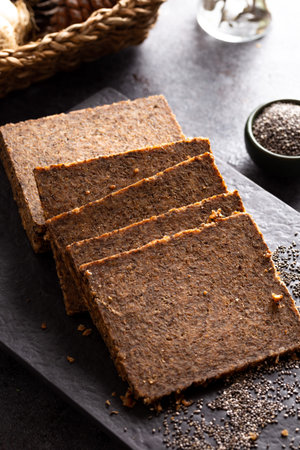 Bread in the form of a flower with oats, flax and chia seed on stone background.