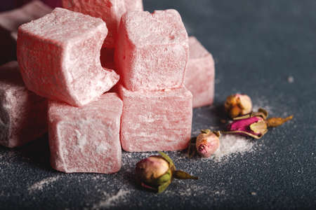 Eastern sweets, Turkish delight with rose on dark background.の写真素材