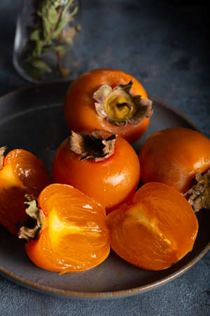 Slices of fresh persimmon. Autumn still life of fresh kaki.の写真素材
