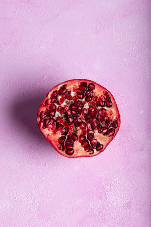 Pomegranates cut open with pomegrante seeds. Fruit minimalism creative concept.の写真素材