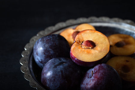 Purple plum slice. Close-up. Ripe, juicy plums.