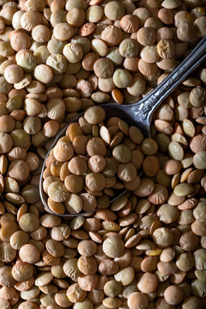 Green lentil in with spoon. Close up. Top view. Food background.