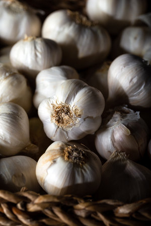 Garlic bulbs in basket on wooden background.の写真素材