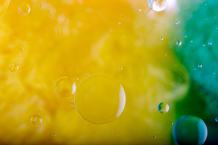 Oil drops on a water surface. Abstract and background.
