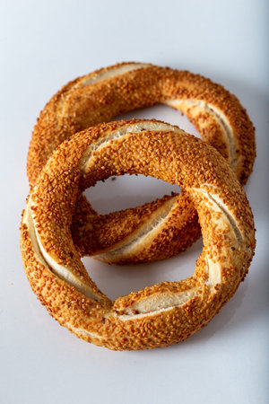 Traditional Turkish bagel (simit) on white background.