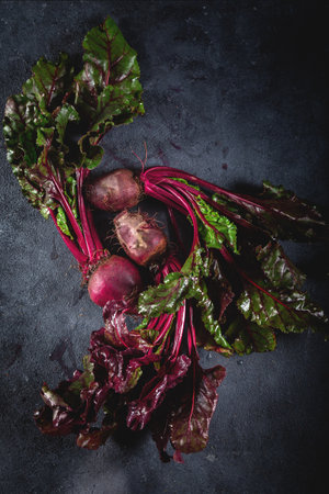 Fresh organic beet, beetroot. Grey background. Copy space. Top view. Beetroot with herbage on dark background.の素材 [FY310164478077]