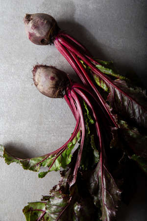 Fresh organic beet, beetroot. Top view. Beetroot with herbage on brown stone background.の写真素材