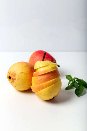 Fresh pears on the white background. Fresh whole pear and slices isolated on white background.の写真素材