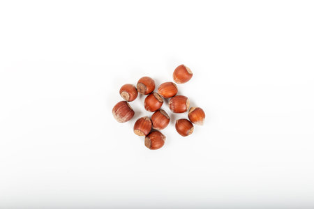 Fresh shelled hazelnuts isolated on a white background.
