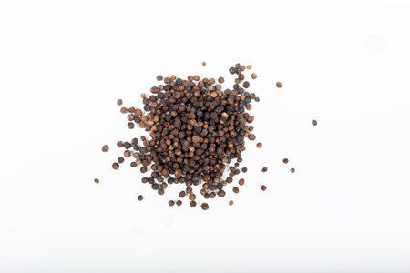 Pile of Black peppercorns (Black pepper) seeds isolated on white background.