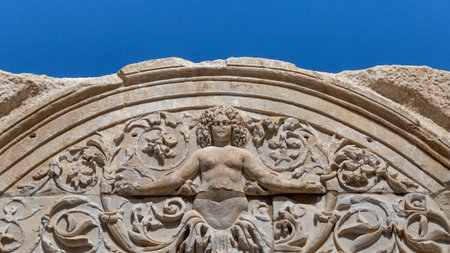 Marble reliefs in Ephesus historical ancient city, in Selcuk, Izmir, Turkey. Hadrian Temple and stone arch with a Medusa figure in Ephesus Ancient City .の写真素材