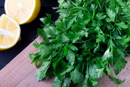 Fresh parsley and lemon on a wooden board. Selective focus.の写真素材