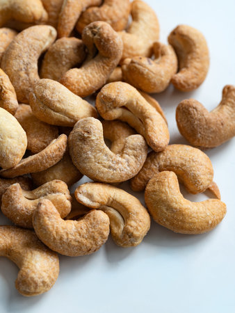 Roasted Cashew Nuts Close-Up on White Backgroundの写真素材