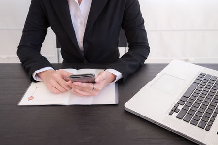 Bussiness woman working on working tableの写真素材