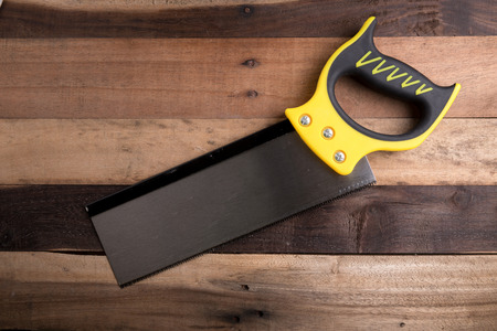 saw on the wooden blackgroundの写真素材