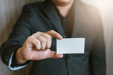Business man holding white business card.の写真素材