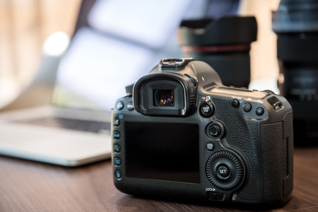 Digital Photography Workstation. Digital DSLR Camera, Laptop Computer.の写真素材