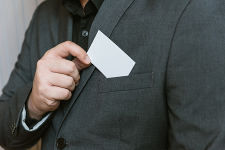 Business man holding white business card.の写真素材