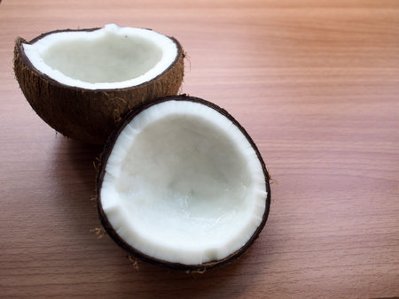 The Dissected coconut on wooden background.