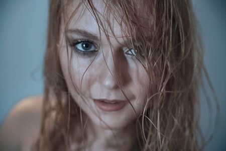 Closeup cropped portrait of a beautiful young woman with bare shoulders.の写真素材