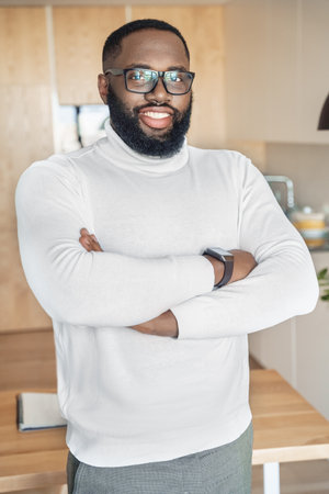 Portrait of confident smiling african american man with folded arms on chestの写真素材